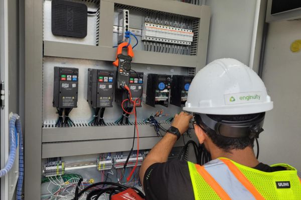 Automation Engineer Ahmad Kammonah putting the final touches on the control panel.